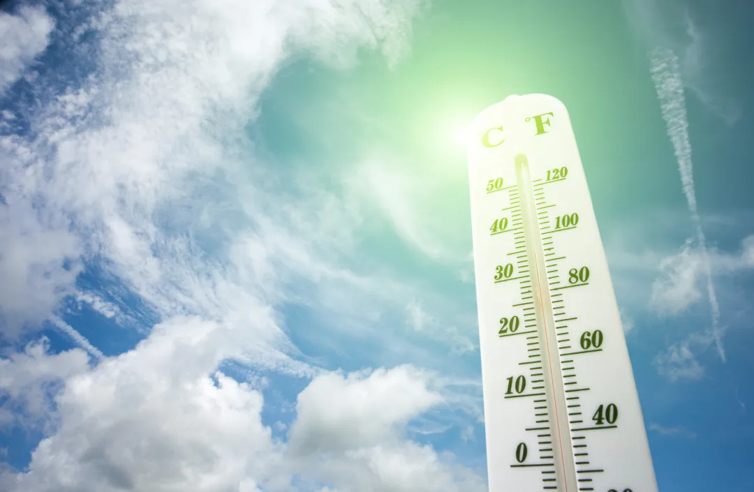 Outdoor thermometer against a clear blue Scottsdale sky showing extreme heat